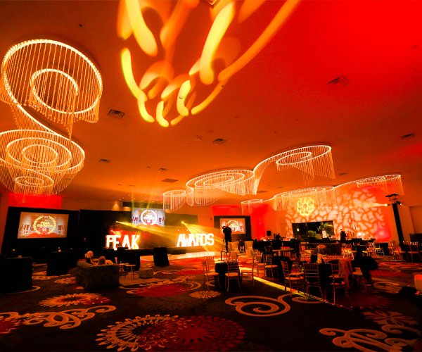 Corporate Events 2 A shining indoor event with bold text reading "Peak Awards"