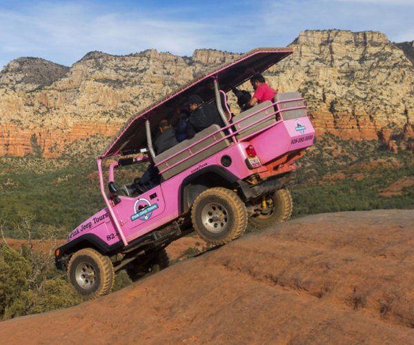 Destination Management 1 Pink Jeep Off Road Terrain Vehicle touring Broken Arrow Slick Rock with Tourists onboard