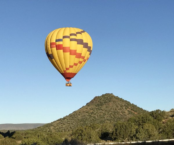 Destination Management 3 A hot air balloon over desert mountains