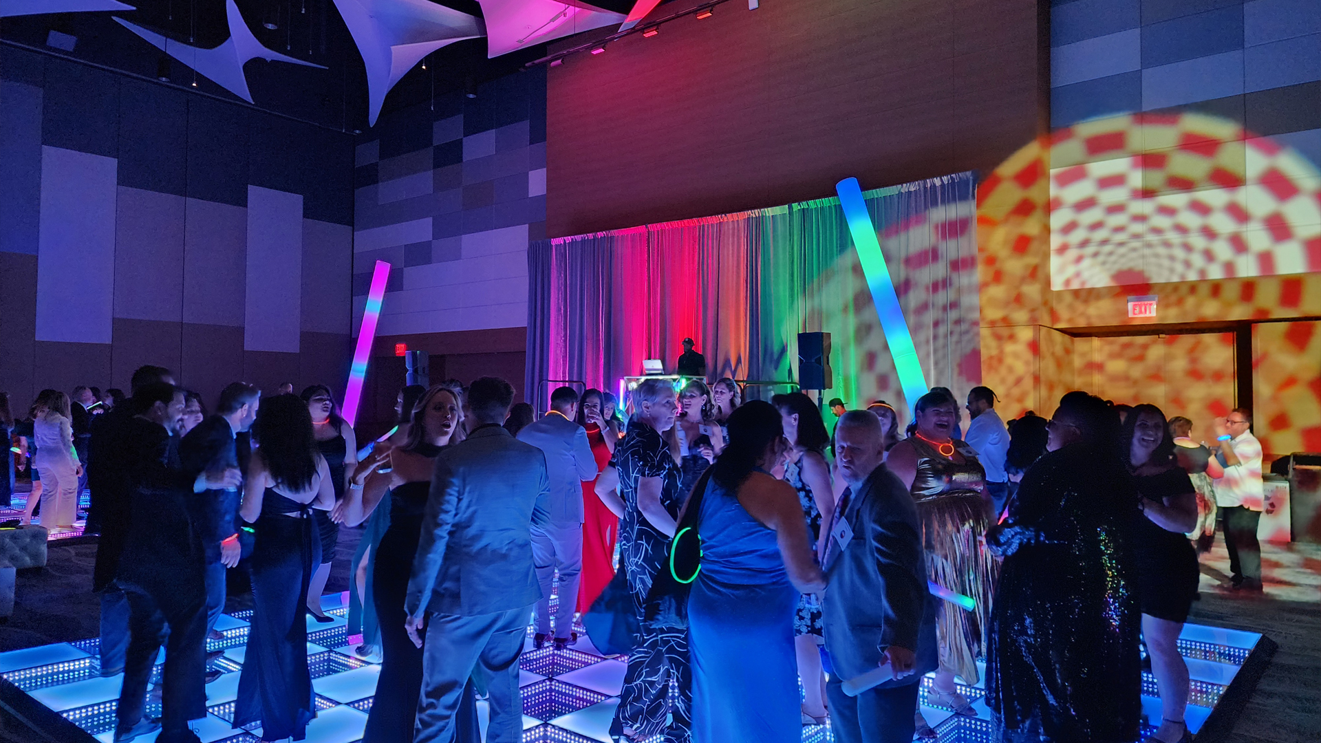 Guests party on a lit-up dance floor